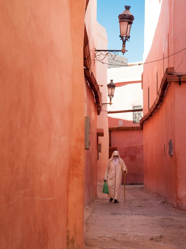 Woman walking through a narrow alley in Marrakesh