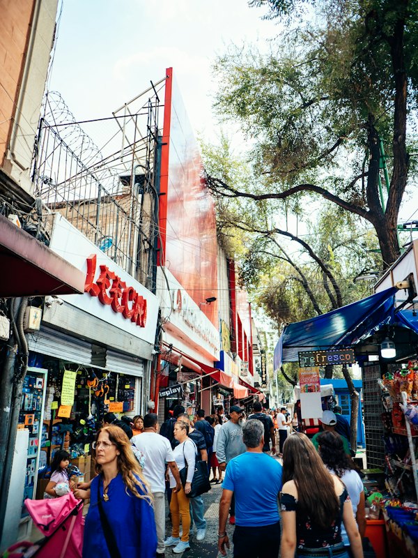 People walking past shopfronts in Mexico City